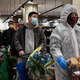 Residents wear protective masks as they line up in a grocery store on February 12, 2020 in Wuhan, China.